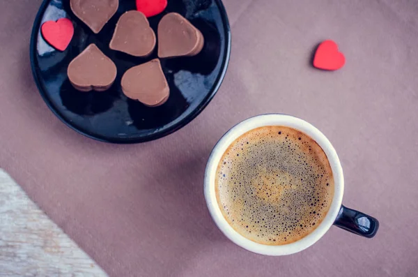 Cup of coffee with chocolate sweets — Stock Photo, Image