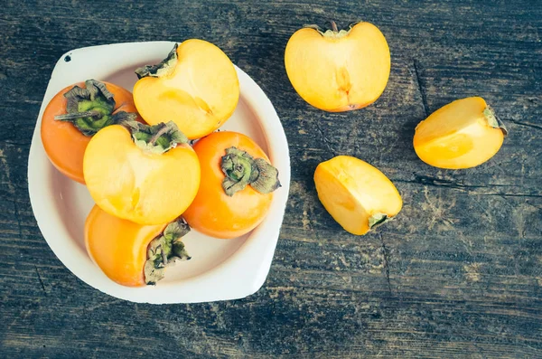 Delicious fresh persimmon fruit on wooden table — Stock Photo, Image