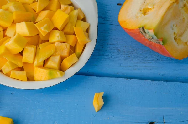 Autumn raw sliced pumpkin on blue wooden background — Stock Photo, Image