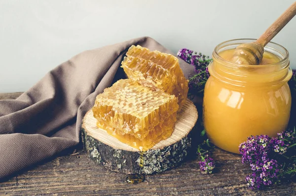 Vaxkakor och glas kruka med honung — Stockfoto