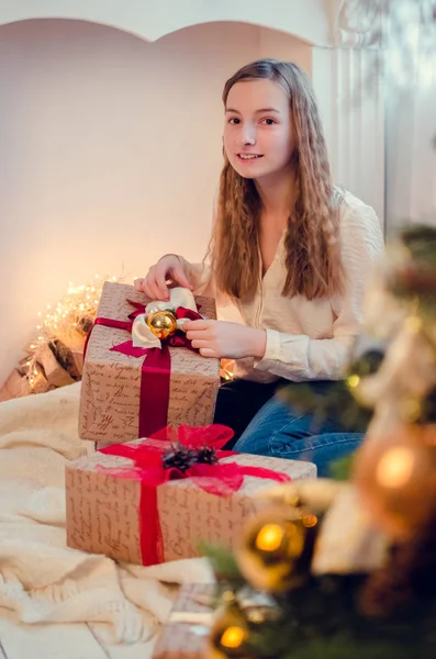 stock image Teenage girl opening the present