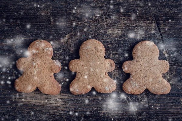 Christmas gingerbread men cookies on wooden background
