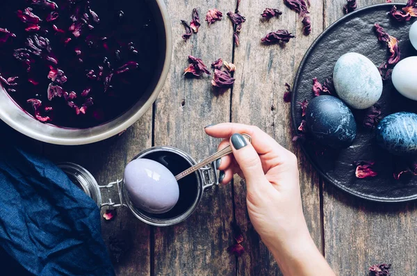 Mermer taş efektli boyalı Paskalya yumurtaları eski ahşap arka planda bulunan amber çiçeklerinin doğal boya oymalı çayıyla boyanmış. Paskalya için yumurta boyama işlemi. Üst görünüm.