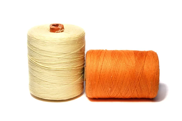 The spool of thread in yellow and orange on a white background — Stock Photo, Image