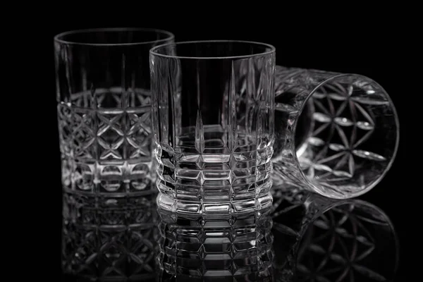 Three Transparent Glasses Whiskey Various Geometric Patterns Stand Black Glossy — Stock Photo, Image