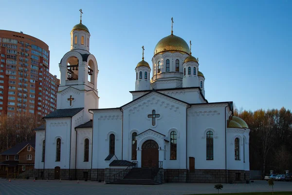 White-stone Orthodox church lit by the rays of the setting sun