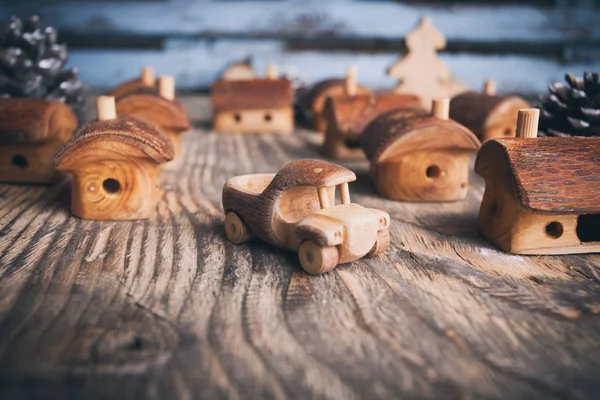 Toy wooden car in wooden town against the background of an old v