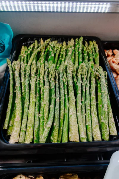 frozen asparagus in a freezer display case