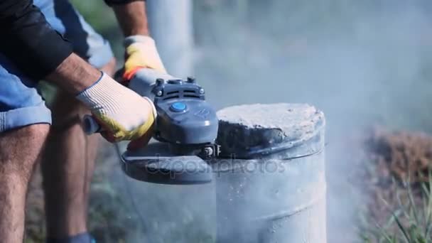 Man cutting a concrete column. Sparks of metal and concrete dust. — Stock Video