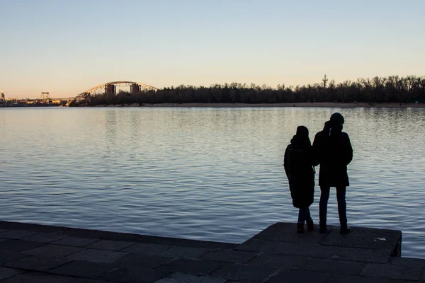 Silhouetten Zweier Junger Menschen Die Den Sonnenuntergang Über Dem Fluss — Stockfoto