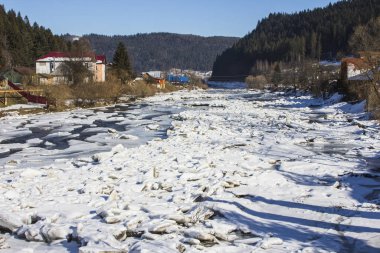 The frozen river Prut in the Carpathian village of Yaremche. Ukraine