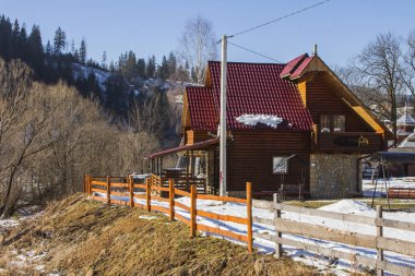 Modern wooden rural house in a typical Carpathian village in winter. Ukraine