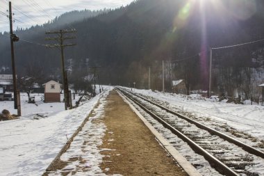 Railway track in the Carpathian Mountains near Yaremche village in winter. Ukraine
