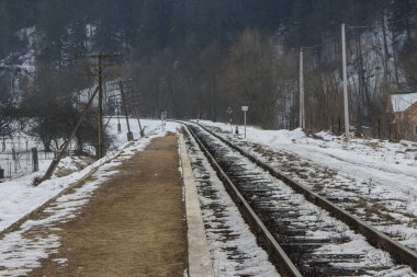 Railway track in the Carpathian Mountains near Yaremche village in winter. Ukraine