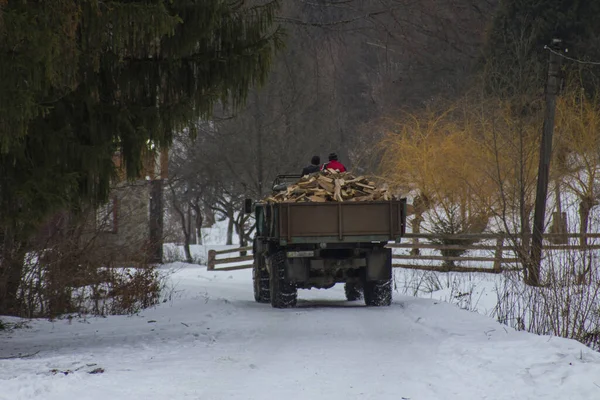A truck loaded with firewood travels down the street of the Carpathian village of Yaremche in winter. Ukraine