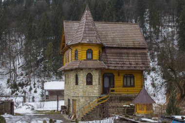 Modern wooden rural house in a typical Carpathian village in winter. Ukraine