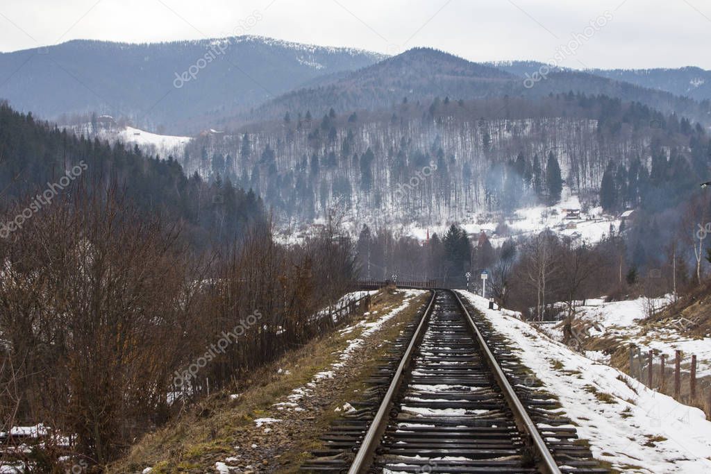 Railway track in the Carpathian Mountains near Yaremche village in winter. Ukraine