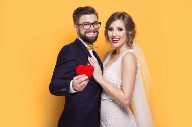 Genç çift kırmızı kalp taşıyor.