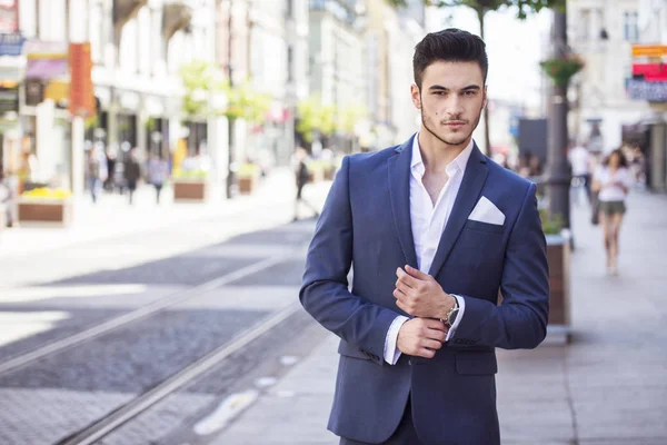 Joven hombre de negocios guapo vestido elegante, caminando por la ciudad Imagen De Stock