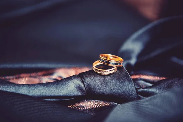 Two wedding rings on mens tie — Stock Photo, Image