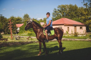 Adam at sırtında yürüyor. Kavram: hobi, hobi, doğa, hayvanlar