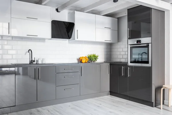 Gray kitchen with brick wall — Stock Photo, Image