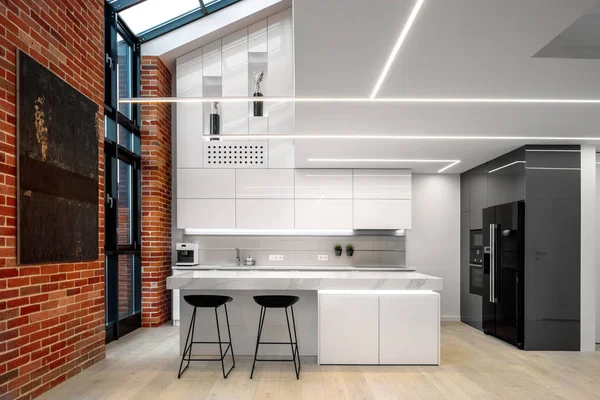 Elegant kitchen with brick wall