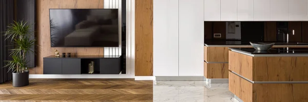 Panorama of apartment with wooden floor in living room and marble floor in kitchen