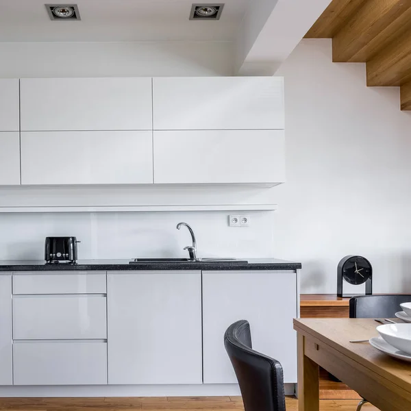 Elegant Kitchen White Cupboards Black Countertops Decorations Wooden Table Floor — Stock Photo, Image