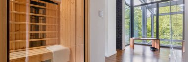 Panorama of finnish home sauna in modern apartment with glassed walls in corridor with wooden bench clipart