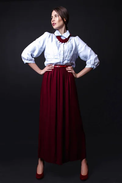 Elegant girl in denim blouse and red skirt in studio on white background — Stock Photo, Image