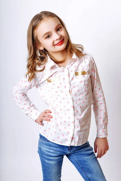 Cute little girl with red lips posing in studio — Stock Photo, Image