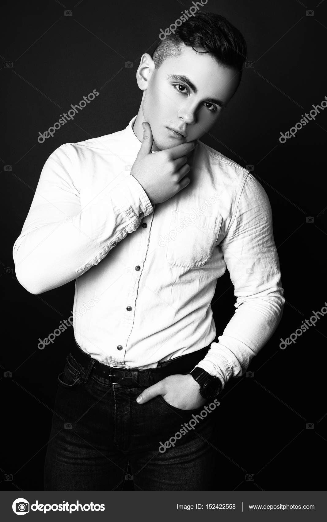 Fashion photo of young model man on black background. Boy