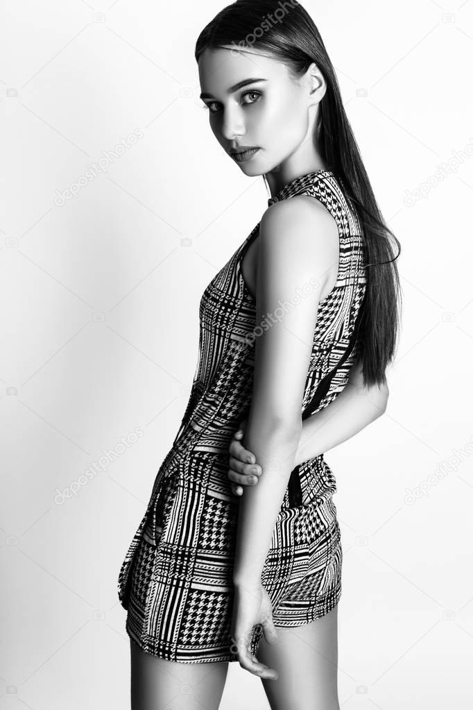 Beautiful woman glamor model fashion clothes wear, casual style. Pretty face dark hair white background studio. Black and white