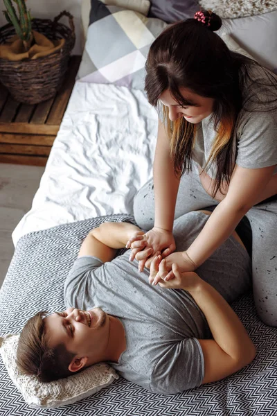 Happy young pregnant couple in bedroom at home — Stock Photo, Image