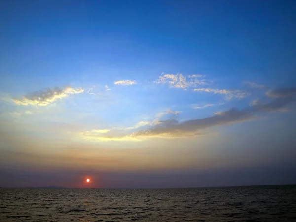 Sunset on the sea and oval cloud blue sky — Stock Photo, Image