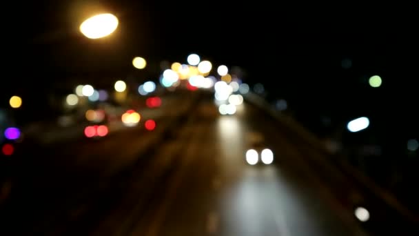 Blur bokeh on night road and light of vehicle — Stock Video