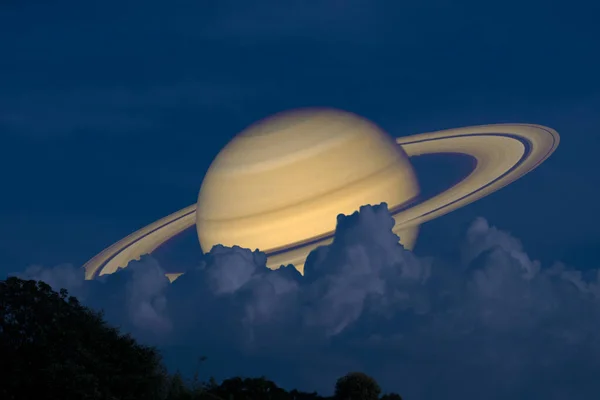 Saturn on night sky back silhouette mountain and heap cloud — Stock Photo, Image