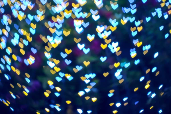 Abstracto borroso bokeh corazón forma amor día de San Valentín en el árbol en ga —  Fotos de Stock