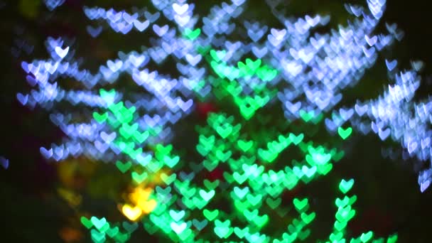 Blur blue green hearts shape night light in the garden — Stock Video