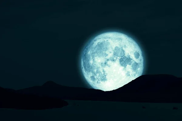 Full Snow Moon on night sky back silhouette island in the ocean — 스톡 사진