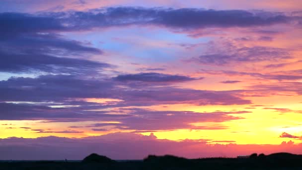 沙滩上的落日和轮廓沙地，天空上的冷蓝调和炽热的红调云 — 图库视频影像