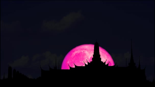 4k luna llena rosa subida de nuevo en silueta buddhist templo — Vídeos de Stock