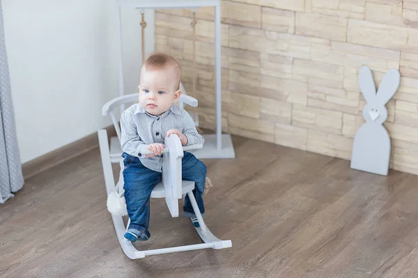 Baby swinging on a rocking chair — Stock Photo, Image