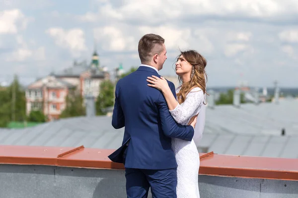 Bride and groom on the roof — Stock Photo, Image