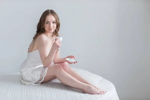 Girl with Cup of coffee in the bedroom — Stock Photo, Image