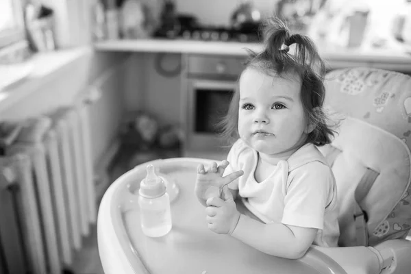Cute girl sitting in the highchair — Stock Photo, Image