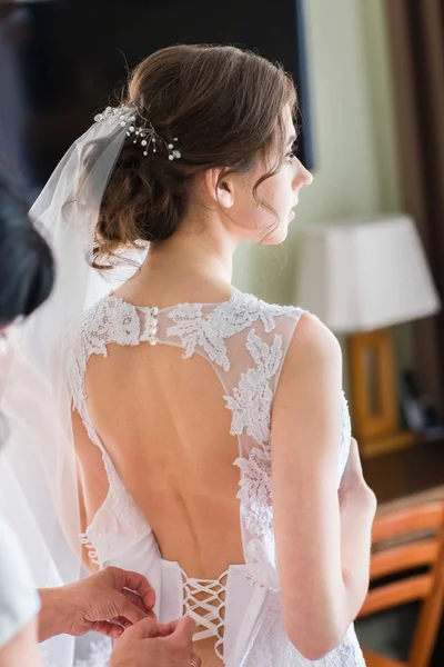 Bride holds her wedding dress — Stock Photo, Image
