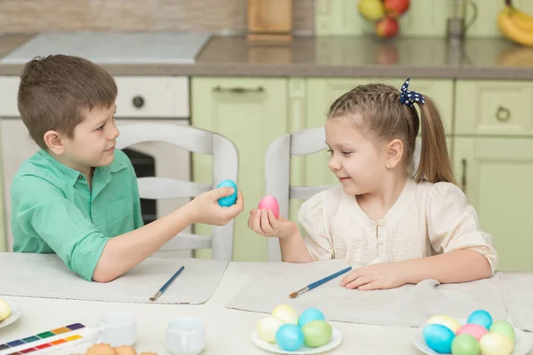 Children boy and girl playing with Easter eggs and laugh Stock Photo
