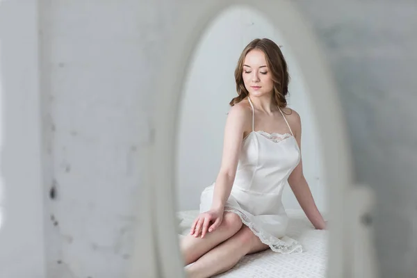 Gentle girl in elegant lingerie in front of the mirror — Stock Photo, Image